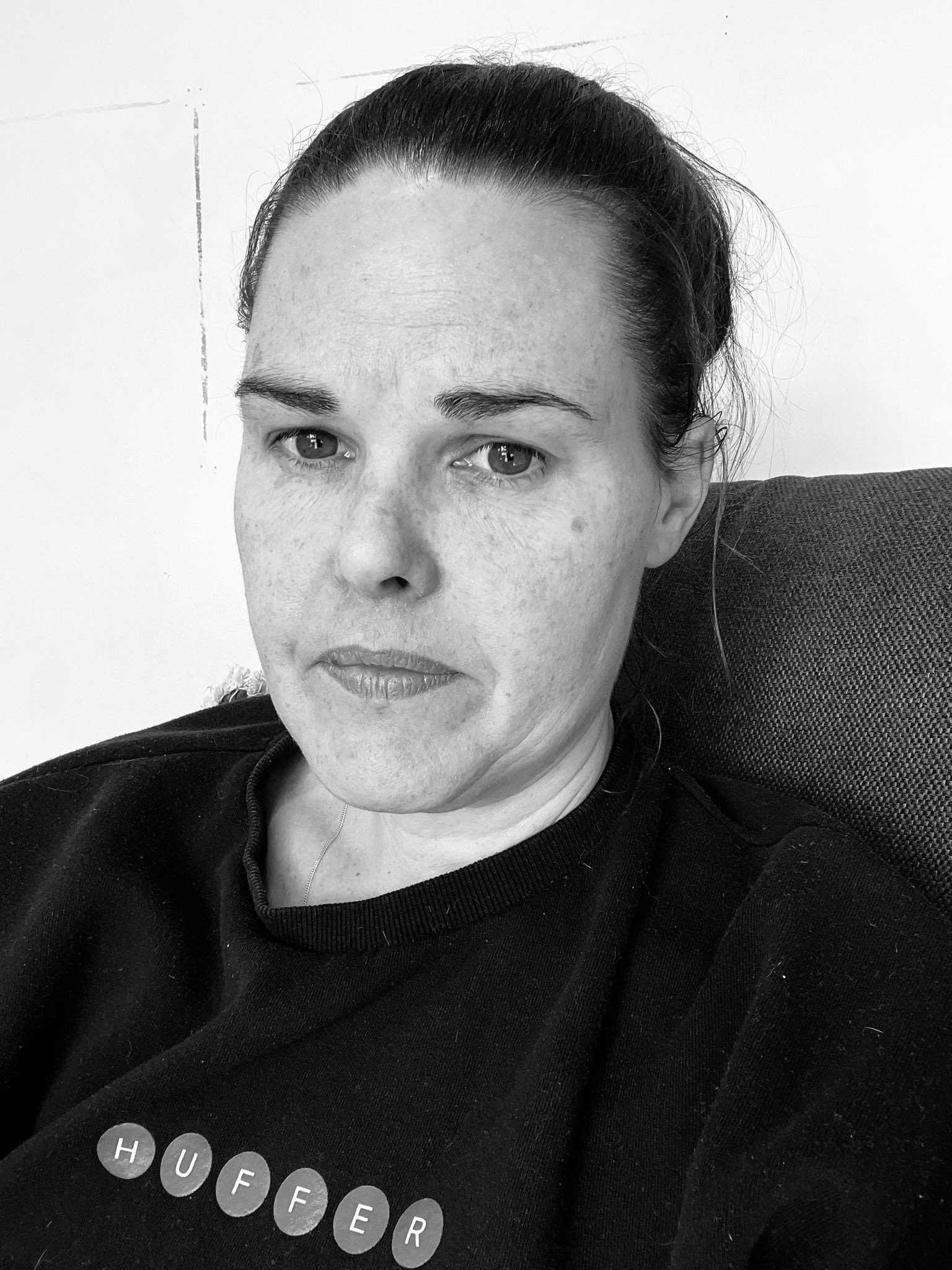 Zalie is looking directly at the camera with a pensive expression on her face.